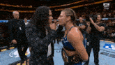 two women are facing each other in a boxing ring and the ufc logo is visible