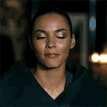 a woman is making a funny face with her eyes closed .