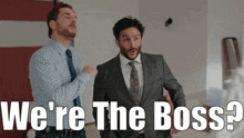 two men standing next to each other with the words " we 're the boss " behind them