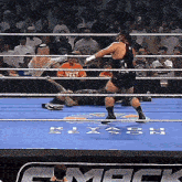 two wrestlers in a ring with the word riyadh season on the floor