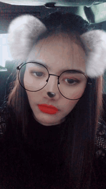 a woman wearing glasses and furry ears has red lipstick