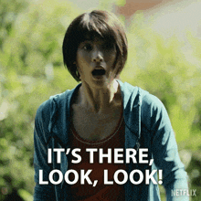 a woman with a surprised look on her face says it 's there look look netflix