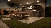 a patio with a dining table and chairs and a grill