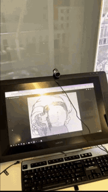 a wacom computer monitor shows a drawing on the screen