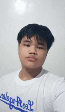 a young man taking a selfie wearing a shirt that says calgary