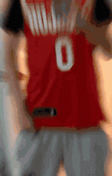 a person wearing a red jersey with the number 0 on it