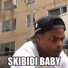 a man wearing a baseball cap is saying skibidi baby