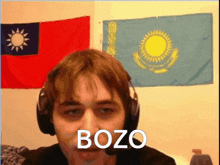 a man wearing headphones says bozo in front of a flag