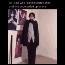 a man in a tuxedo is standing in a room next to a wall with pictures on it .
