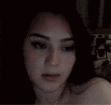 a close up of a woman 's face with her eyes closed