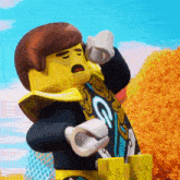 a lego figure with the letter g on his sleeve