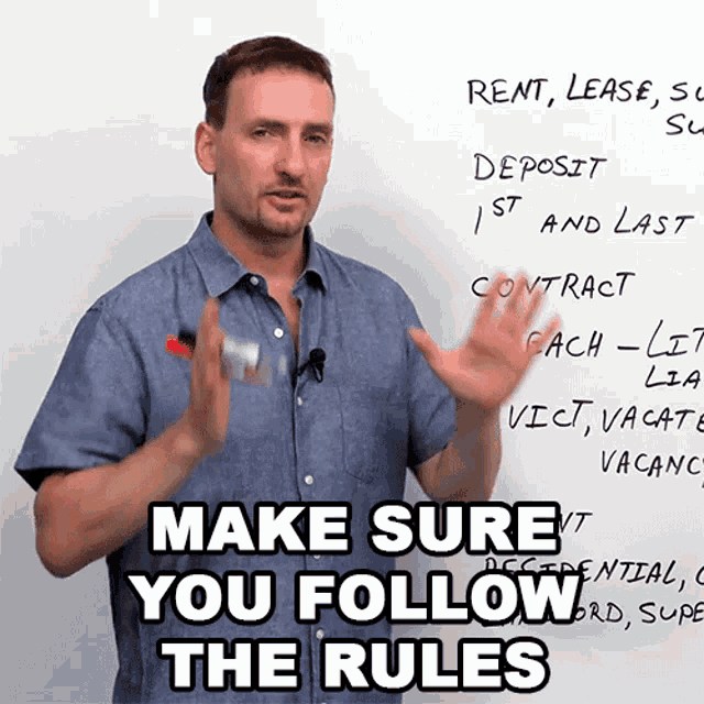 a man stands in front of a white board with the words make sure you follow the rules on it