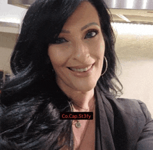 a woman is smiling with a co.cap.st3fy watermark on her face