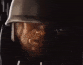 a close up of a man wearing a helmet and headphones .