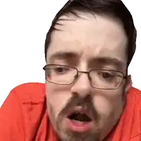 a man wearing glasses and a red shirt makes a funny face