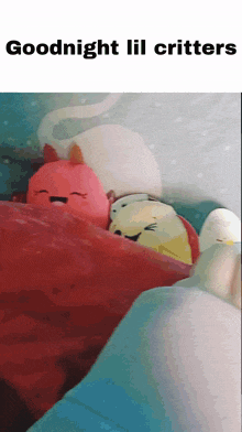 a bunch of stuffed animals are wrapped in a red blanket with the words goodnight lil critters on the bottom