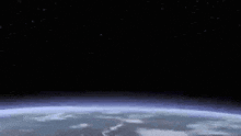 a view of the earth from space with a bright star in the background .