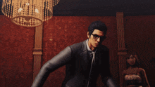 a man in a suit is throwing money in the air while a woman in a black dress watches