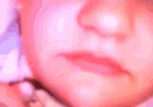 a close up of a child 's face with a blurred background