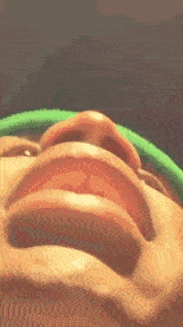 a close up of a person 's face with a green headband on