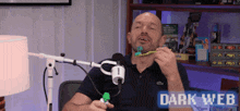 a man is brushing his teeth in front of a microphone with the words dark web on the bottom right
