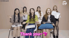 a group of girls are sitting in a classroom and one of them says thank you