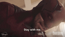 a man in a daredevil costume is saying stay with me