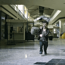 a man carrying a bag runs through a mall