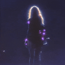 a woman is singing into a microphone while wearing a sparkly outfit