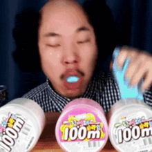 a man is eating a container of 100ml toothpaste