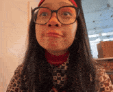 a woman wearing glasses making a funny face