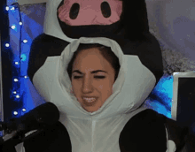 a woman is wearing a cow costume and smiling
