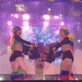 a couple of people are dancing in front of a purple background