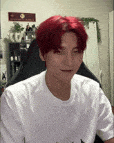 a young man with red hair is sitting in front of a hogwarts express sign
