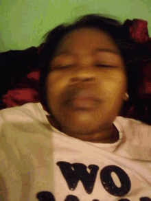 a girl wearing a white shirt that says " mom " on it
