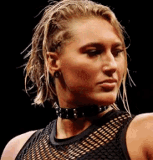 a woman wearing a choker and a black tank top