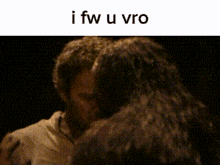 a man and a woman are hugging each other in the dark .
