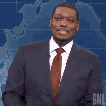 a man in a suit and tie with snl written on the bottom