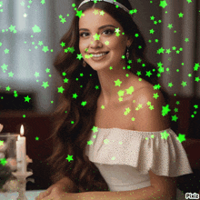 a woman in a white dress with green stars around her face