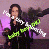 a woman wearing headphones says " i 'm a tiny book " while standing in front of a microphone