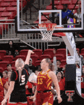 a female basketball player wearing a number 13 jersey tries to block a shot