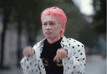 a person with pink hair is wearing a polka dot jacket and a black shirt