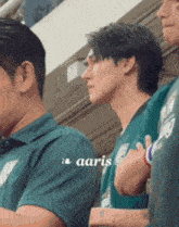 a man in a green shirt with the word aaris on the bottom