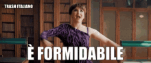 a woman in a purple dress is standing in front of a sign that says " trash italiano "
