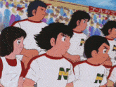 a group of boys wearing shirts with the letter n on them stand in front of a crowd