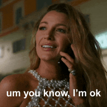 a woman talking on a cell phone with the words um you know i 'm ok written below her