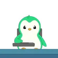 a green and white penguin is sitting at a table