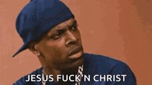 a man wearing a blue hat and a blue shirt is talking about jesus .