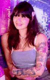 a woman with a flower in her hair has a tattoo on her arm that says ' i love you '