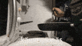 a person is stirring food in a frying pan with the words " kayn syomas " written above it